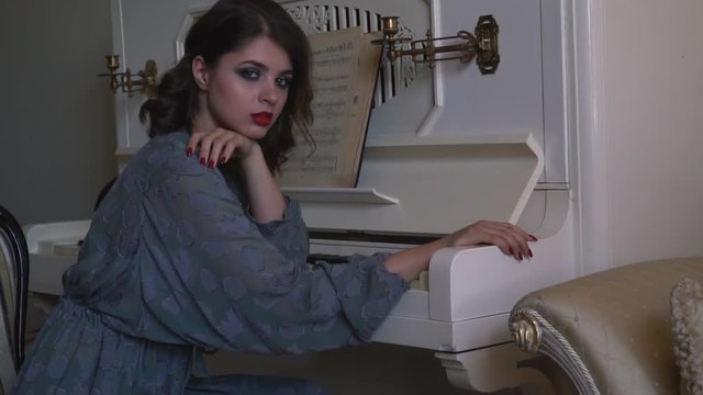 A young girl is placed near the piano and dreams