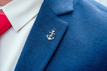 interesting details on the jacket, red tie on the white shirt of the groom