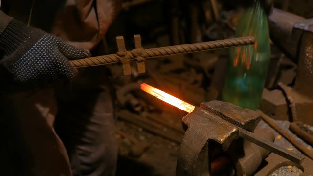 Professional blacksmith working with metal at forge, workshop. Handmade, craftsmanship and blacksmithing concept