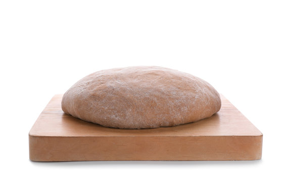Wooden board with raw rye dough on white background