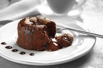 Plate of delicious fresh fondant with hot chocolate on table. Lava cake recipe