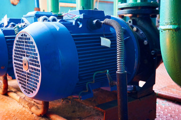 Blue electric motor with pump close-up. Abstract background.
