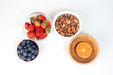 Blueberry Strawberry Herb Spice Almond Cashew Nut Mandarin Orange in bowl on white background