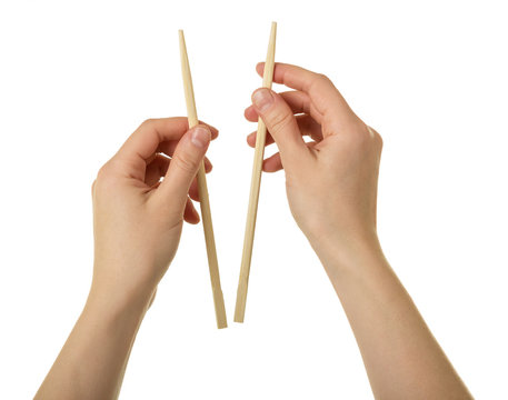 Wooden Chopsticks In Female Hands Isolated On White