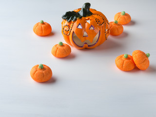 Decorative pumpkin with orange marshmallows on white. Halloween party invitation card