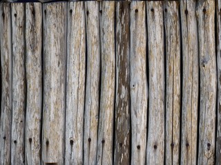 Row of smooth round wooden wood used as a fence