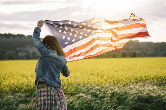 Woman in jeans jacket with American flag