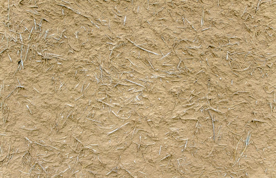 Wall of clay with straw as background