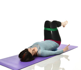 Woman exercising doing postnatal workout. Female fitness instructor working out with a rubber...