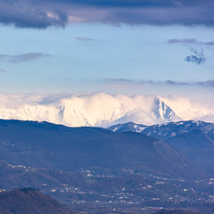The slow flow of the Tagliamento river cradled by its mountains.