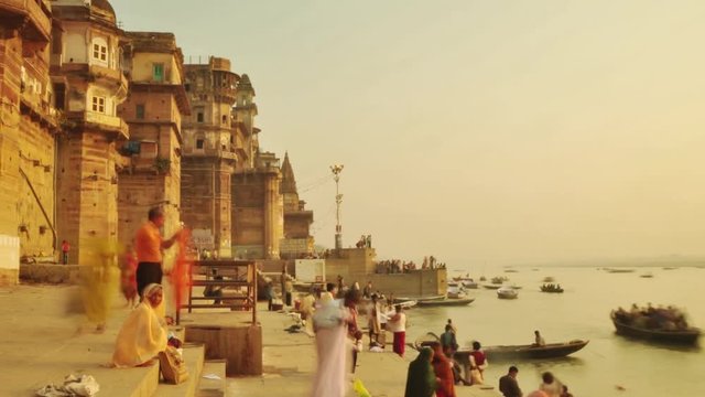 Time lapse Indian pilgrims rowing boat in sunrise. Ganges river at Varanasi India.