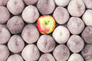 Peach and apple fruit background. Stand out in the crowd.