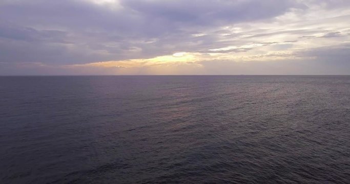 Aerial, beautiful calm sea in the evening and overcast sky