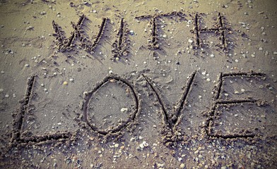 with love written on the beach