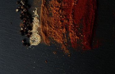 Various spices over a slate board. Top view