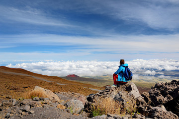 Tourist admiring breathtaking view of Mauna Loa volcano on the Big Island of Hawaii.