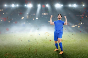 Fototapeta na wymiar Handsome asian soccer player man happy celebration