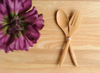empty wood plate with fork and flower decorate