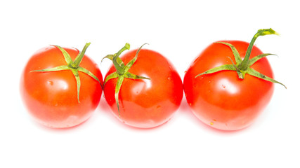 Three red tomatoes on a white background
