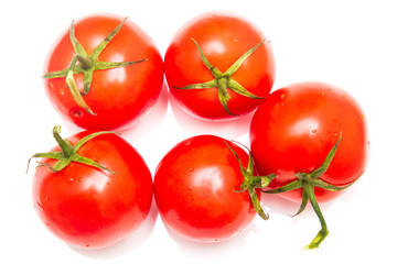 Five red tomatoes on a white background