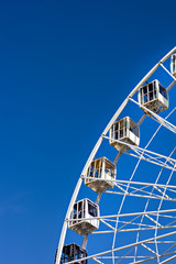 Ferris wheel on a blue sky background.