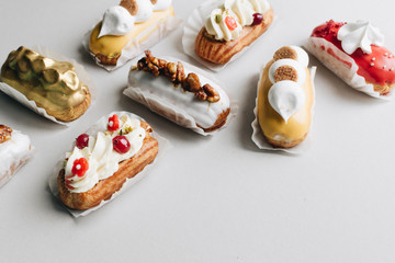 Assorted delicious sweets on grey background