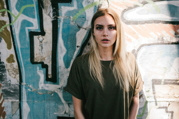Beautiful young blonde girl  in a blank green military T-shirt 