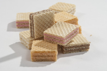 Wafer Cube shape biscuits with orange strawberry and chocolate flavor on a white background