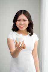 Diet eating / close-up portrait of an attractive young woman eating yogurt