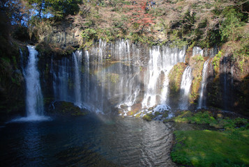 Fototapeta na wymiar Shiraito-no-taki waterfall with the rainbow in autumn / 秋の白糸の滝(全景) - 虹付き