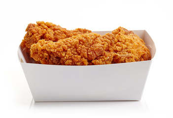 Fried breaded chicken wings in white cardboard box isolated