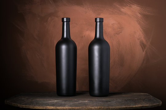 Red wine bottle on a wooden brown background