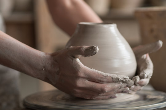 Potter Sculpts A Vase On A Potter's Wheel