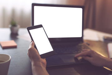 Business woman using laptop and smart phone