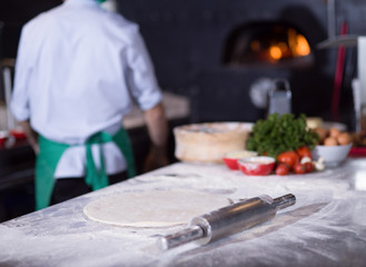 chef preparing dough for pizza