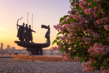 Monument to the founders of Kiev at sunrise, beautiful cityscape with lilac, capital of Ukraine