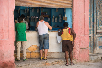 Havana, Cuba. Three people are shopping at a grocery store