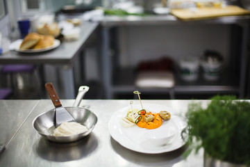fried fish in a frying pan before serving