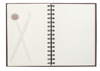 blank page of note book on white with teeth tool