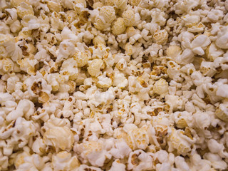 Scattered salted popcorn, texture background.