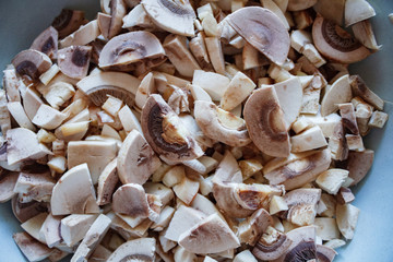 Champignon mushrooms, sacking mat and spices on wooden background