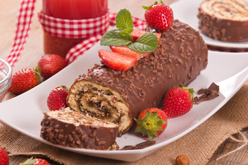 Chocolate roll with strawberries. 