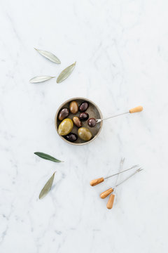 Olives on a marble table.