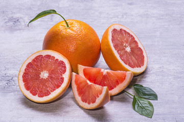 Grapefruit whole, half and slice, green leaf, juicy ripe isolated on a gray background