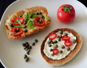 Snacks for breakfast with toasted bread in a white plate.