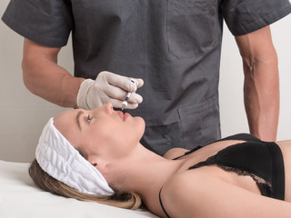 Closeup of beautiful woman receiving hyaluronic acid treatment.