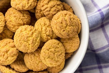Delicious yellow cookie of corn. Sweet food of Festa Junina, a typical brazilian party. Snacks on bowl and rustic fabric.