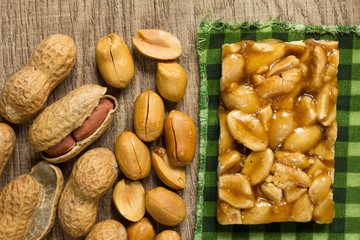 Candy with peanut: Pe de Moleque in Brazil and Chikki in India. Sweet food of Festa Junina, a typical brazilian party. Snack over green plaid fabric.