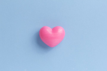 Red heart shape over blue table. Romantic Valentine Day concept with copy space