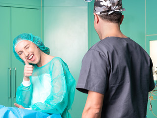 Young surgeon and his patient in operatory room before surgery.